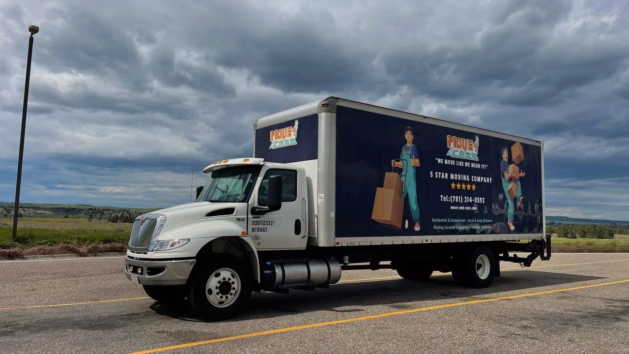 Move and Care 26-foot box truck parked under a cloudy sky